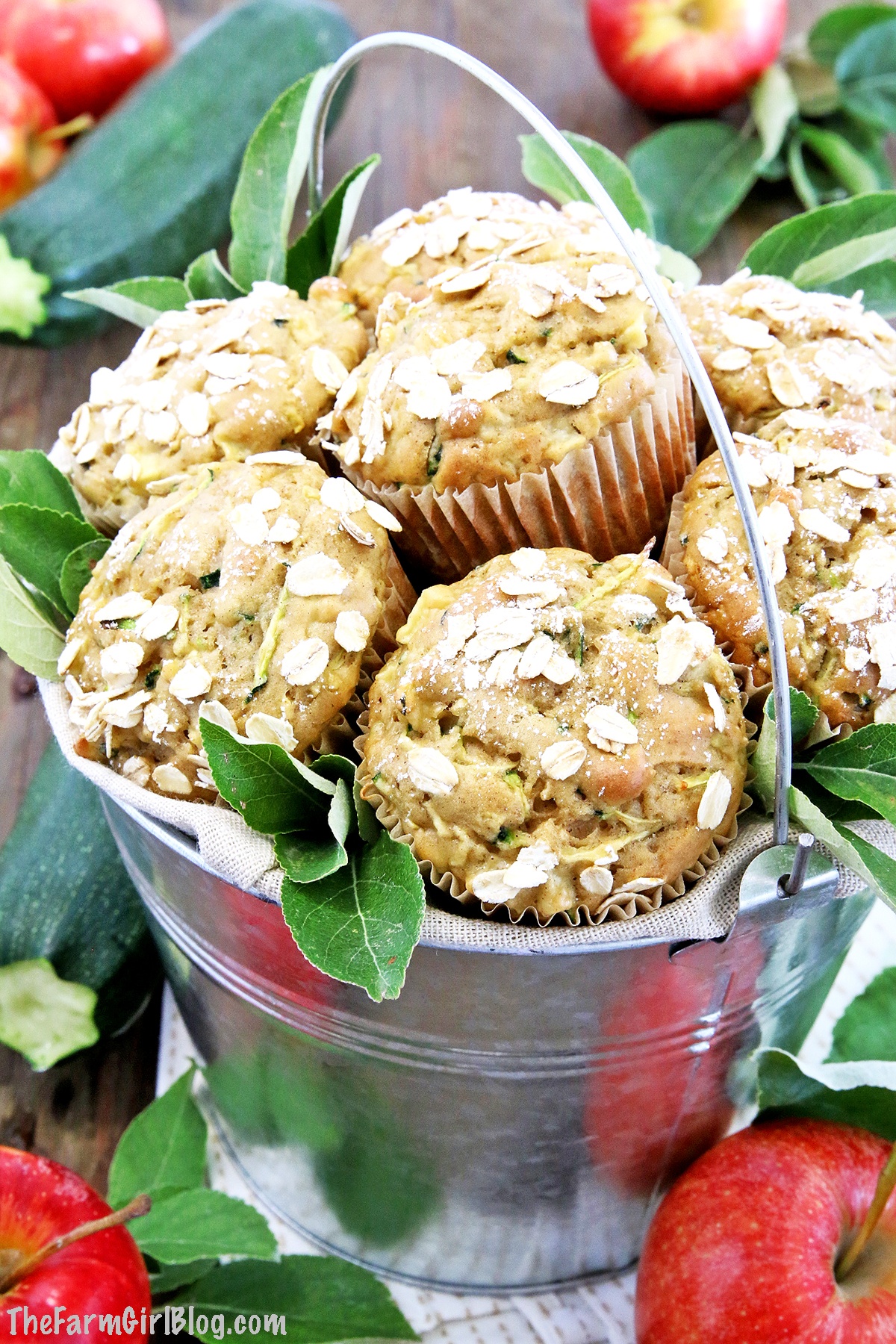 This Apple Zucchini Muffins Recipe is a must-make Fall treat! They are tender, fluffy, airy and loaded with homegrown zucchini and chunks of homegrown apples. I love this recipe because it has no added oil moistener in it, but are only moistened by apple sauce. This adds a rich and delicious taste as well as making them super moist. #applezucchinimuffins #cleaneating #homegrownproduce #thefarmgirlblog